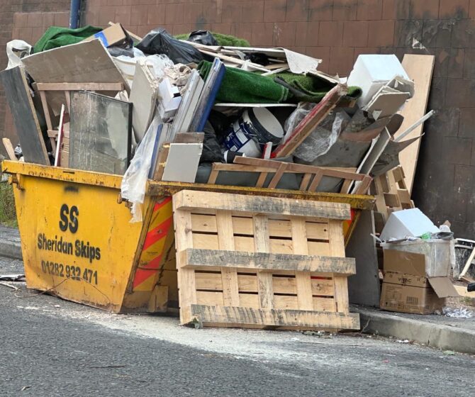 An image of an overloaded skip